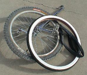 Unicycle with original tire laying on top